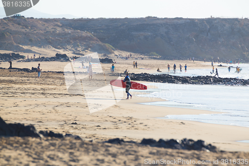 Image of Surfers surfing on El Cotillo beach, Fuerteventura, Canary Islands, Spain.