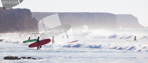 Image of Surfers surfing on El Cotillo beach, Fuerteventura, Canary Islands, Spain.