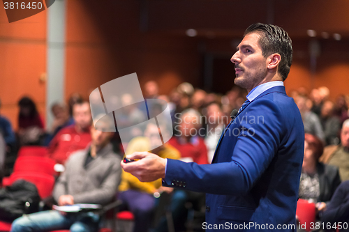 Image of Public speaker giving talk at Business Event.