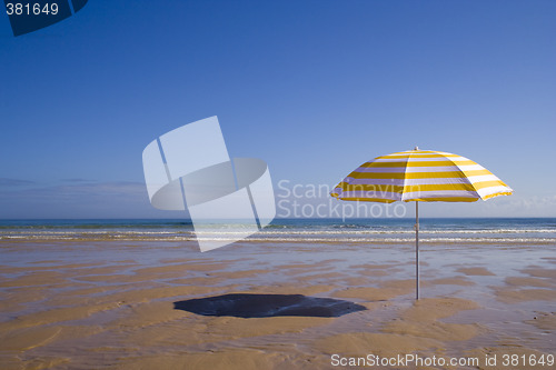 Image of yellow umbrella at the beach