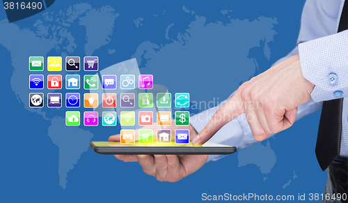 Image of Businessman holding a tablet pc with mobile applications icons on virtual screen . Internet and business concept.