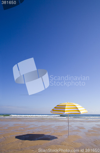 Image of yellow umbrella at the beach