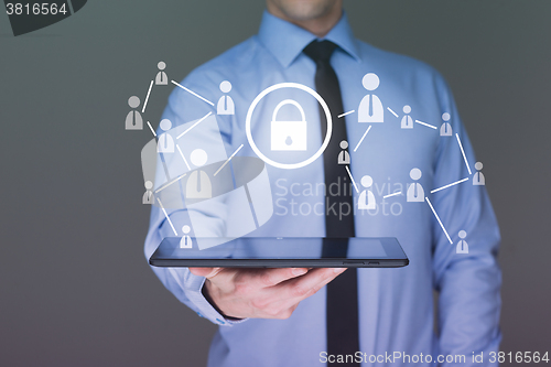 Image of Businessman holding a tablet. with touch screen interface and cyber security concept . 