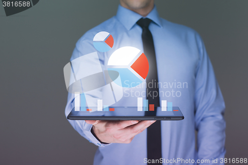 Image of businessman hold tablet with graph on high technology