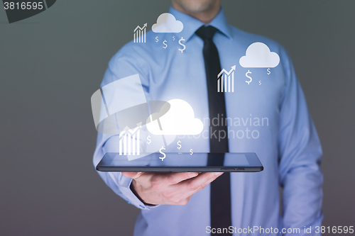 Image of Business man using tablet PC with social media icon set