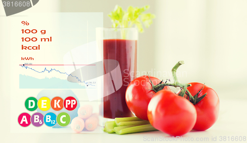 Image of close up of fresh juice and vegetables on table