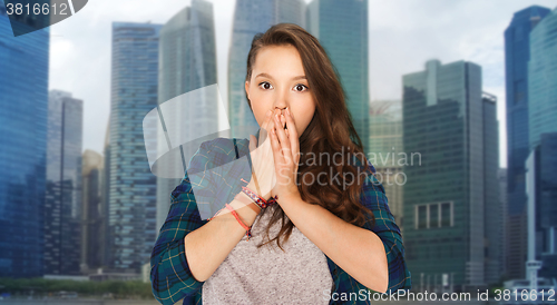 Image of scared teenage girl over singapore city background