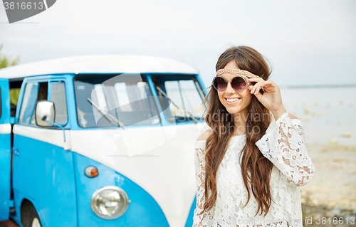 Image of smiling young hippie woman in minivan car