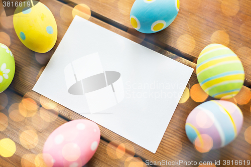 Image of close up of easter eggs and blank white paper