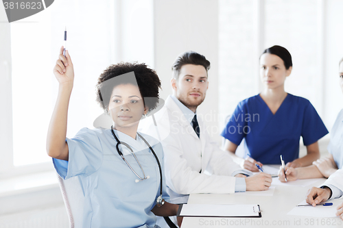 Image of group of happy doctors on conference at hospital