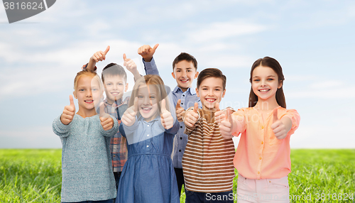 Image of happy children showing thumbs up