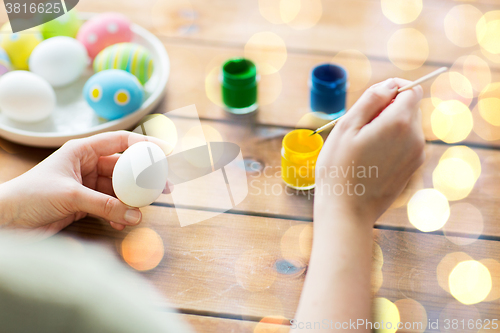 Image of close up of woman coloring easter eggs