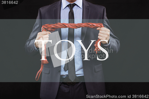 Image of man in business suit with chained hands. handcuffs for sex games. concept of erotic entertainment.