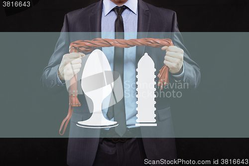 Image of man in business suit with chained hands. handcuffs for sex games. concept of erotic entertainment.