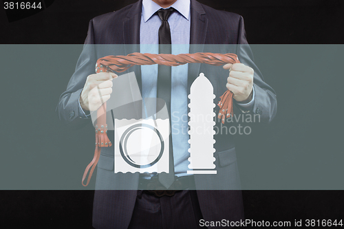 Image of man in business suit with chained hands. handcuffs for sex games. concept of erotic entertainment.