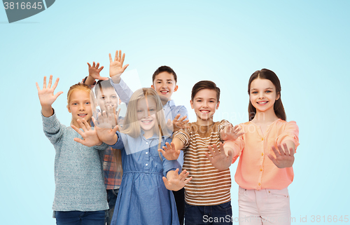Image of happy children waving hands