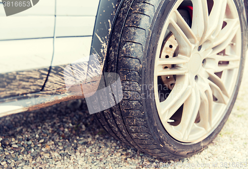 Image of close up of dirty car wheel on ground