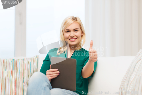 Image of smiling woman with tablet pc at home