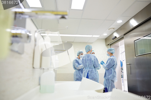 Image of group of surgeons in operating room at hospital