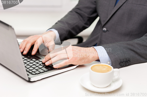 Image of close up of businessman with coffee and laptop