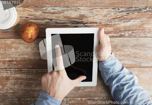 Image of close up of male hands with tablet pc and coffee