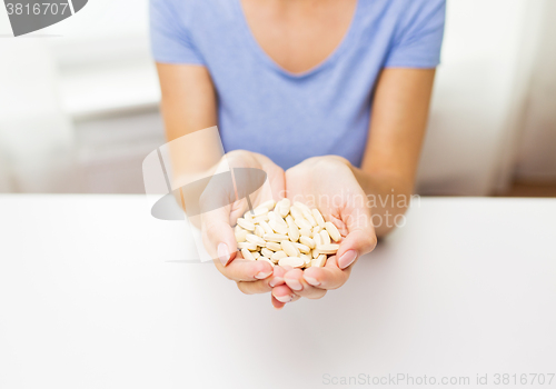 Image of close up of woman hands with medicine or pills