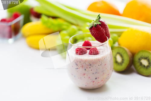 Image of close up of glass with milk shake and fruits