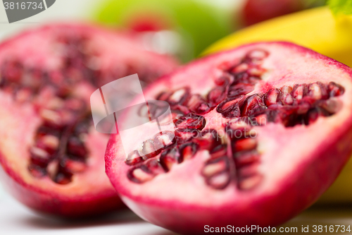 Image of close up of ripe pomegranate and other fruits