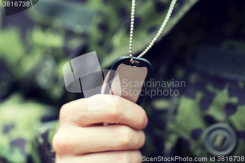 Image of close up of young soldier in military uniform