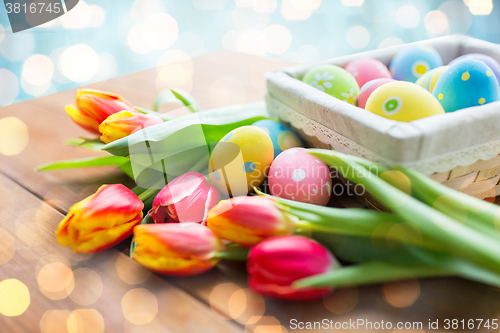 Image of close up of colored easter eggs and flowers