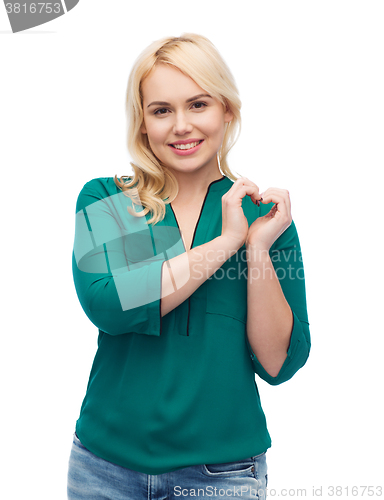 Image of smiling young woman in shirt showing heart shape