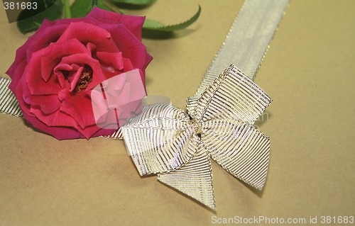 Image of red rose and golden ribbon