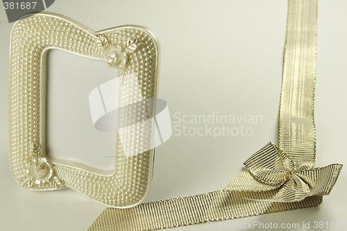 Image of golden ribbon and pearl picture frame