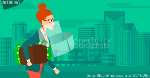 Image of Woman with suitcase full of money.