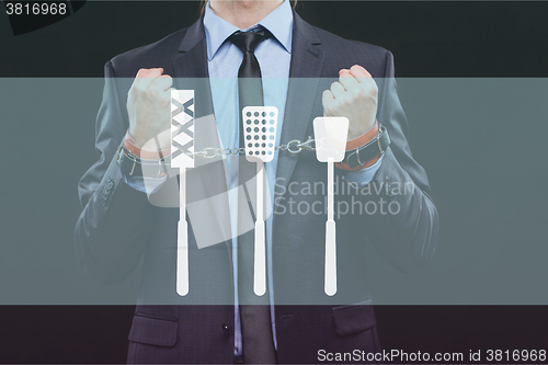 Image of man in a business suit with chained hands. handcuffs for sex games. concept of erotic entertainment.