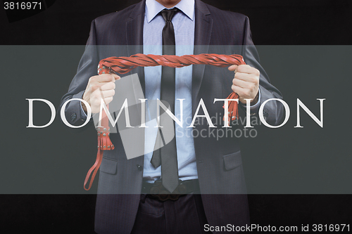 Image of man in business suit with chained hands. handcuffs for sex games. concept of erotic entertainment.