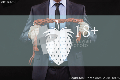 Image of man in business suit with chained hands. handcuffs for sex games. concept of erotic entertainment.