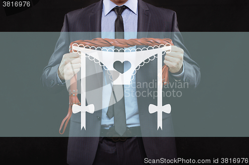 Image of man in business suit with chained hands. handcuffs for sex games. concept of erotic entertainment.