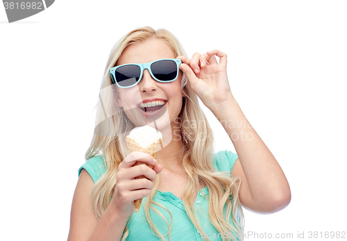 Image of happy young woman in sunglasses eating ice cream