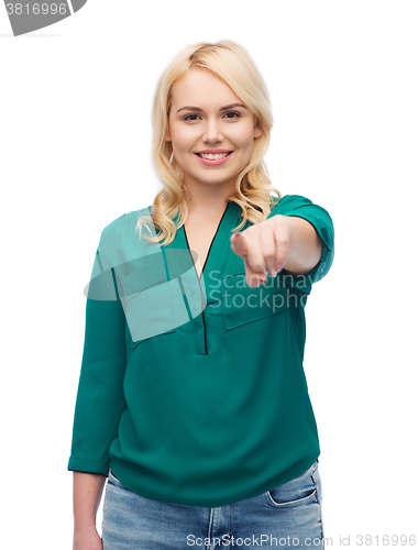Image of smiling young woman pointing finger on you