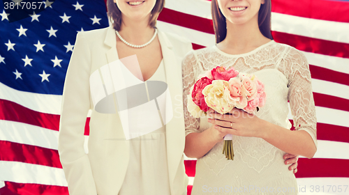 Image of close up of happy lesbian couple with flowers