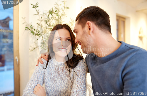 Image of happy couple hugging at cafe or restaurant