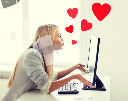 Image of woman sending kisses with computer monitor