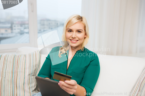 Image of happy woman with tablet pc and credit card