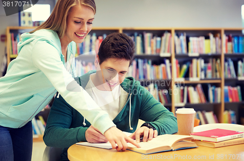 Image of happy students preparing to exams in library