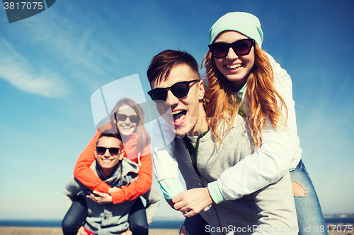 Image of happy teenage friends having fun outdoors