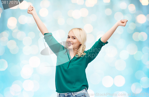 Image of smiling young woman in shirt and jeans