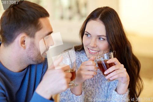 Image of happy couple drinking tea at cafe