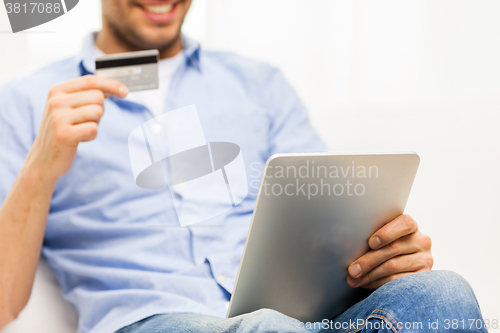 Image of close up of man with tablet pc and credit card