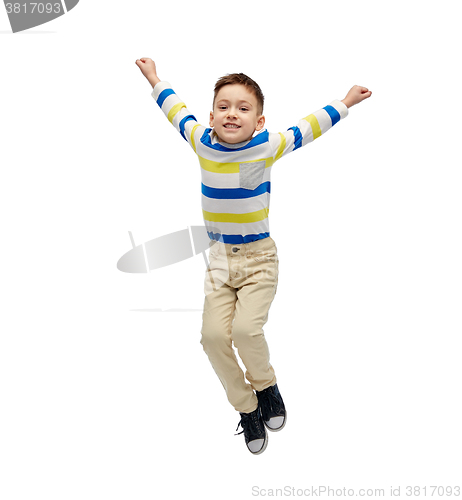 Image of happy little boy jumping in air